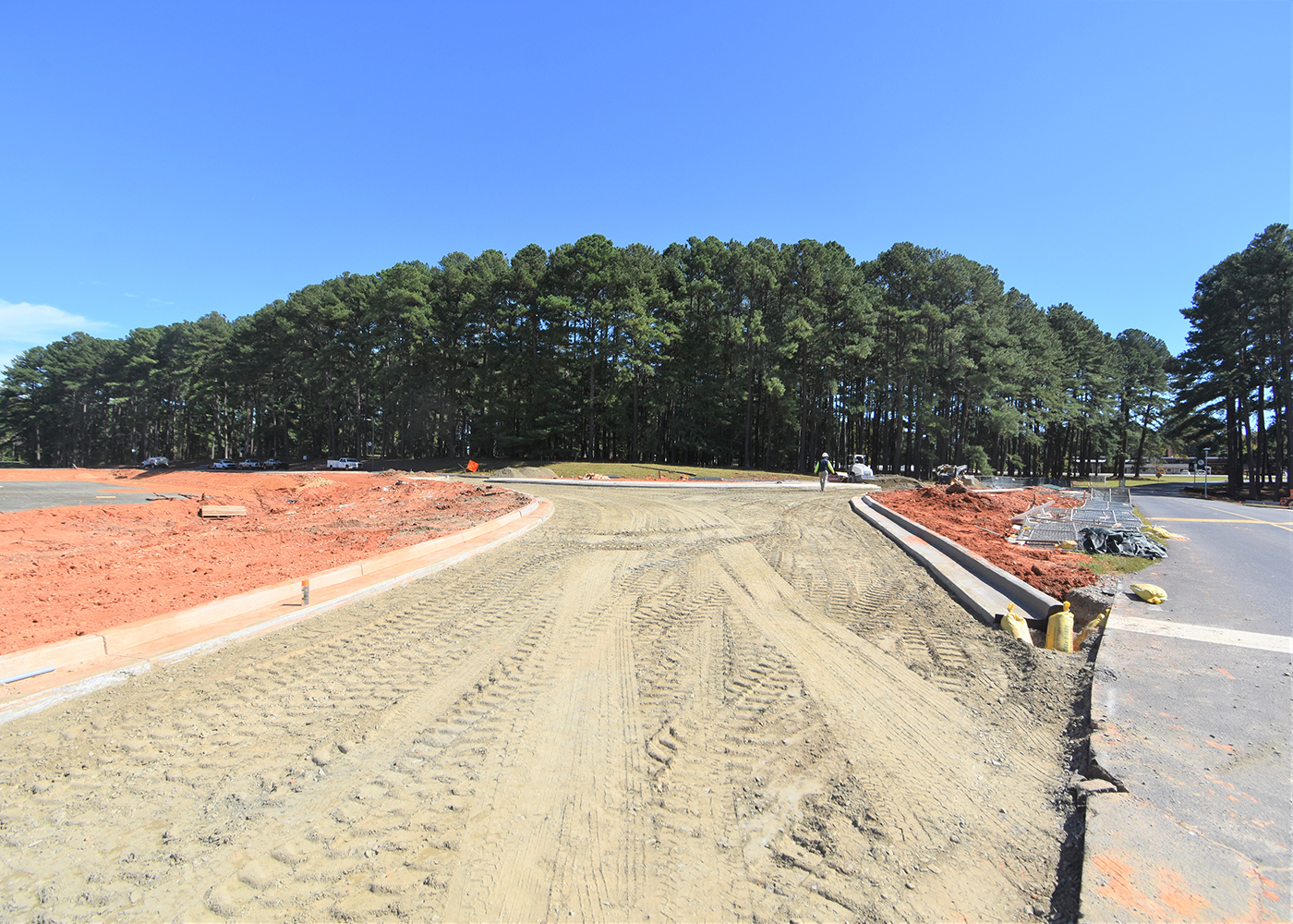 New curbing shows the entrance to the traffic circle. The building site is the gray area on the left, 10/6/2022.