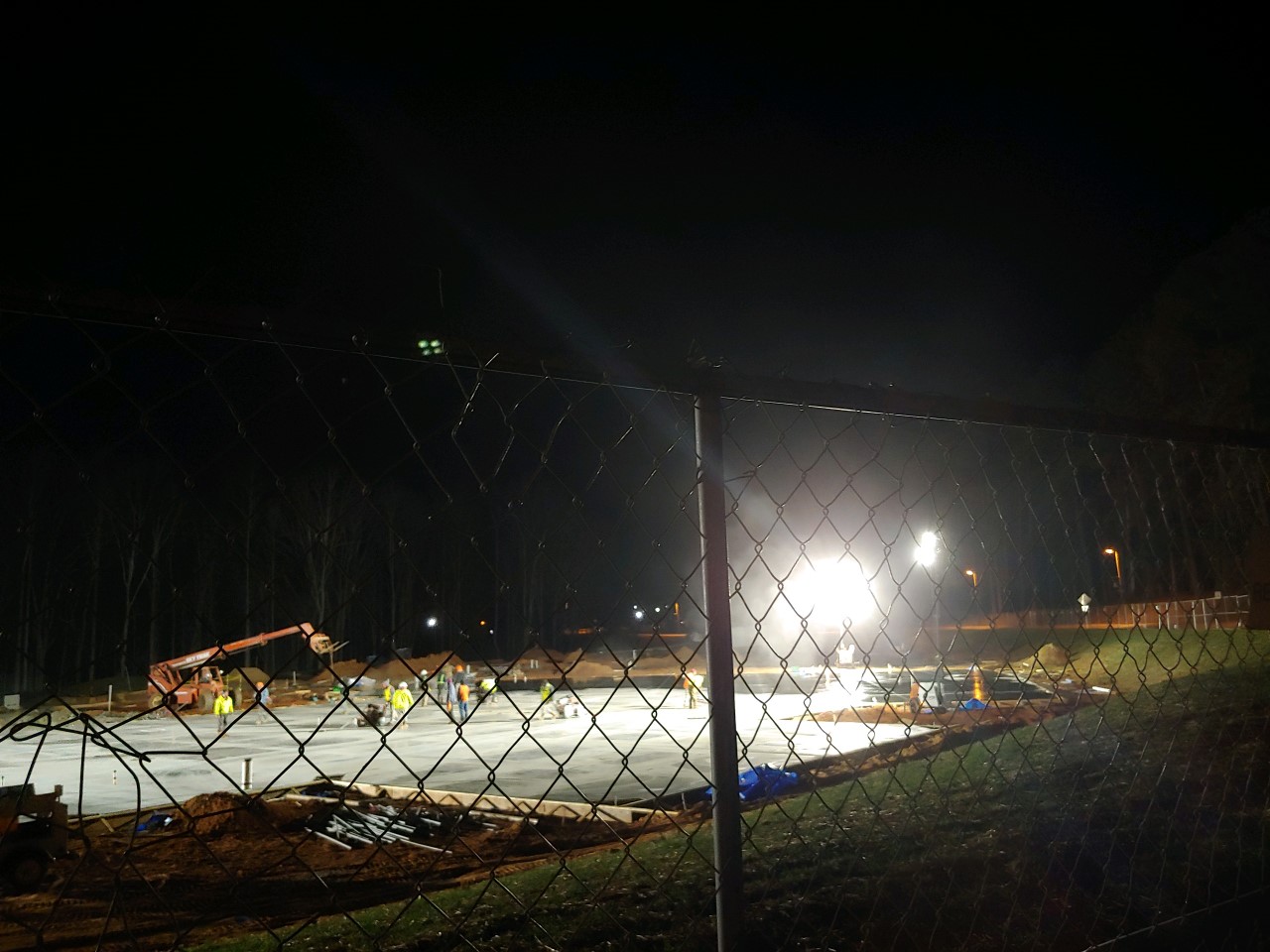 Construction crew continuing to work through the night on the concrete foundation slab, 1/21/2023.