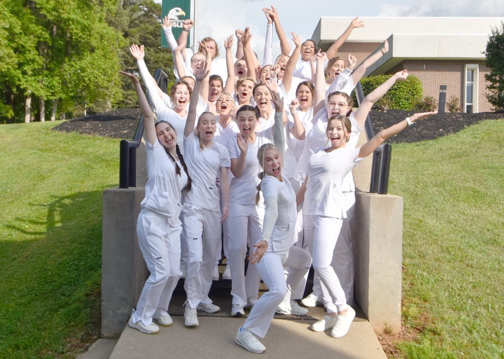 Associate Degree Nursing graduates cheer for a photo