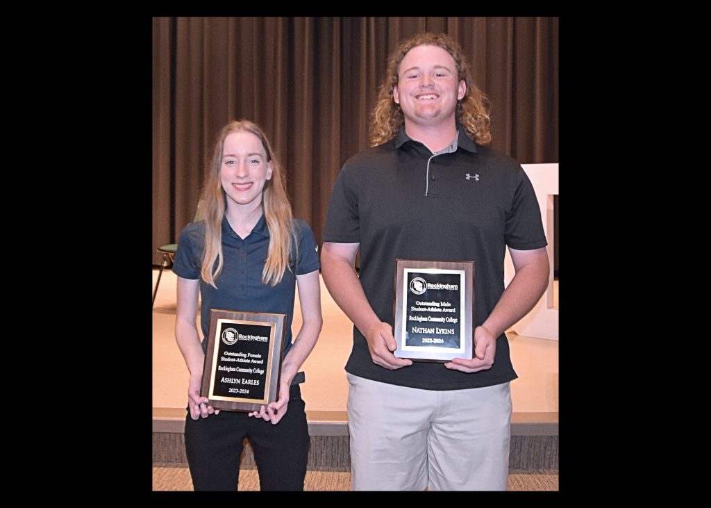 Picture of two students holding plaques.
